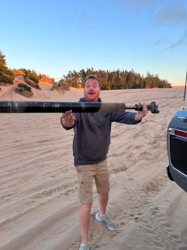 Holding a driveshaft beside the Ford on the Oregon dunes